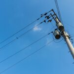 a pole with many wires and a sky background