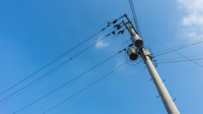 a pole with many wires and a sky background