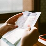 person holding white printer paper