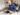 man in blue sweater using macbook pro