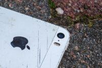 a broken cell phone laying on the ground