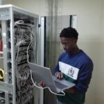 man in blue sweater using silver macbook