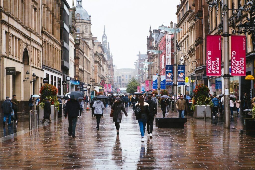 a group of people walking down a street holding umbrellas