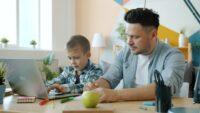 Father and son working together on a laptop.