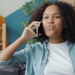 Young woman talking on a cell phone at home.