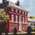 3-story building near fence and trees