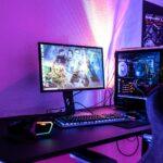 a desk with a computer and a gaming chair