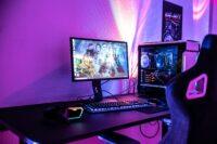 a desk with a computer and a gaming chair