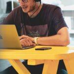 man in black crew neck t-shirt using silver macbook