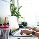 person using macbook pro on table