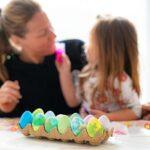 a woman and a little girl sitting at a table
