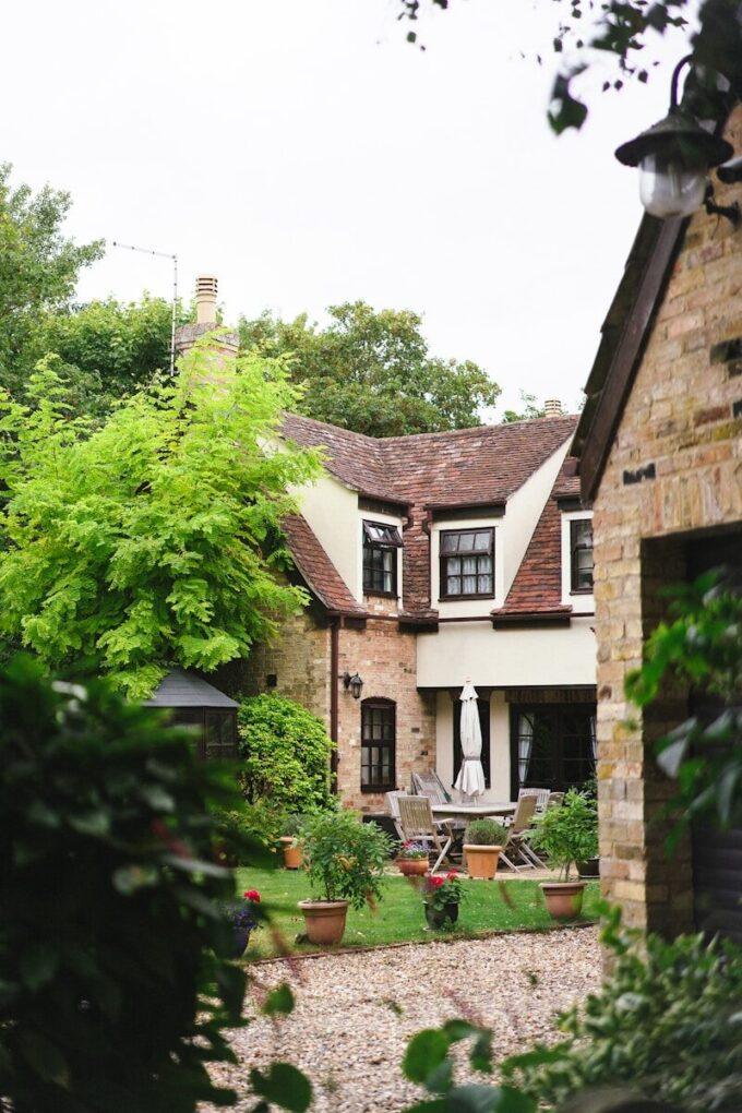 A large house with a lot of greenery in front of it